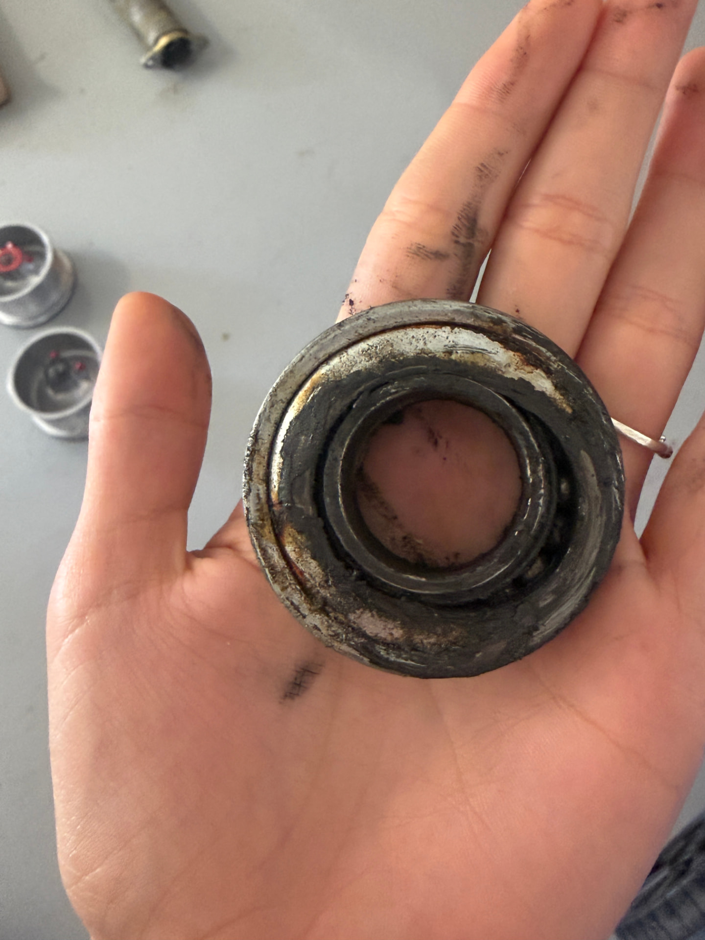 Worn-out garage door bearing removed during service