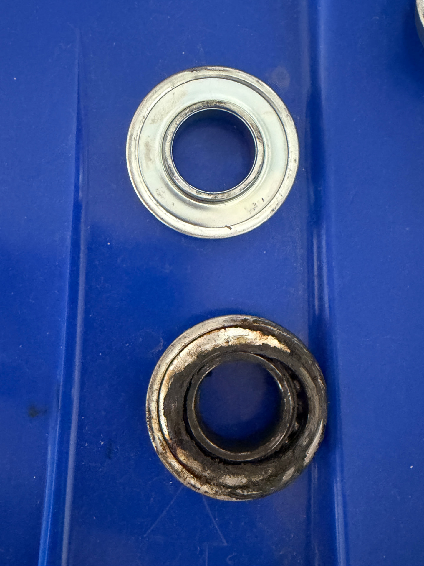 New bearing next to the old worn bearing it replaced